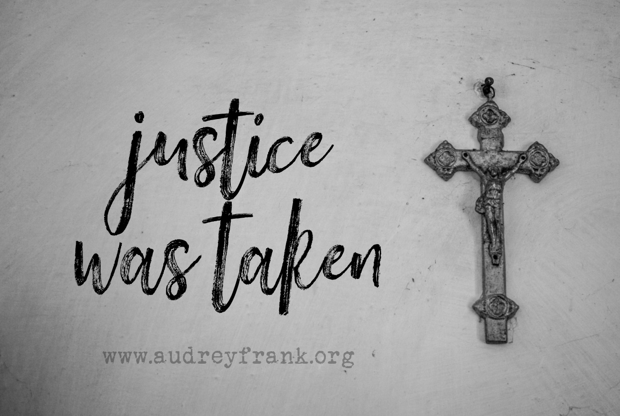 A picture of a crucifix with the words Justice was taken, describing the subject of the post.