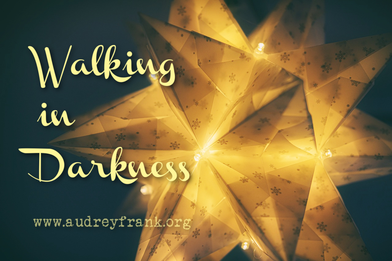  a Christmas star with the words Walking in Darkness describing the subject of the post.